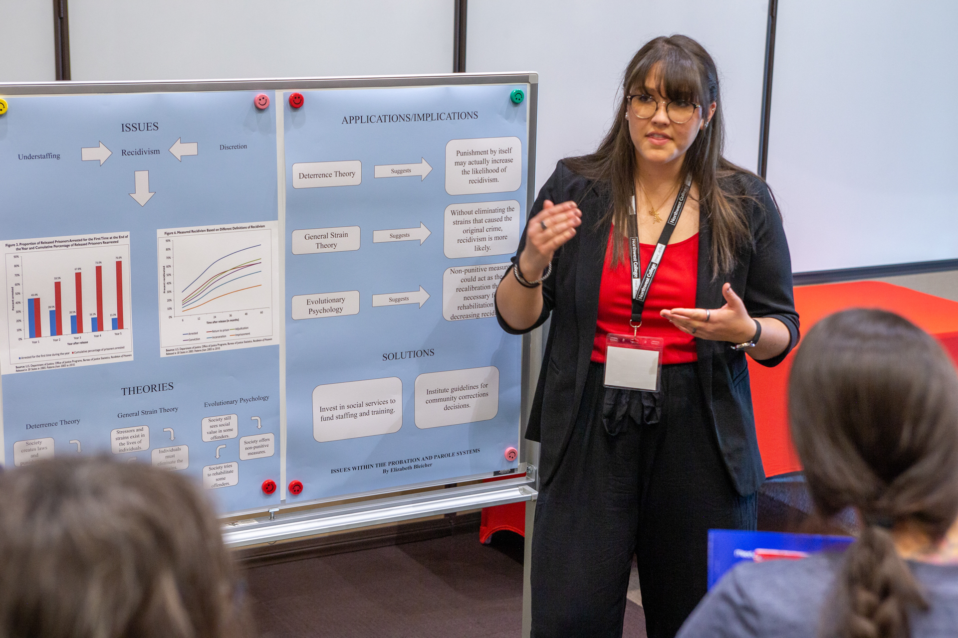 Cover photo for the 2024-2025 Catalog (female presenting research poster to small group of people)